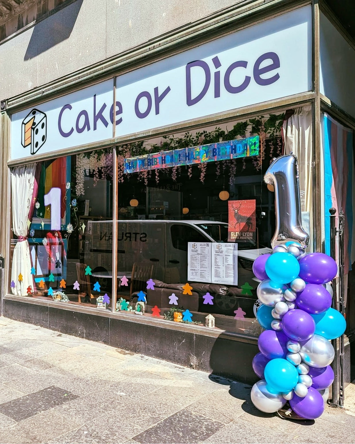 Photo of external of the cafe, with a 1 year old anniversary balloon tower