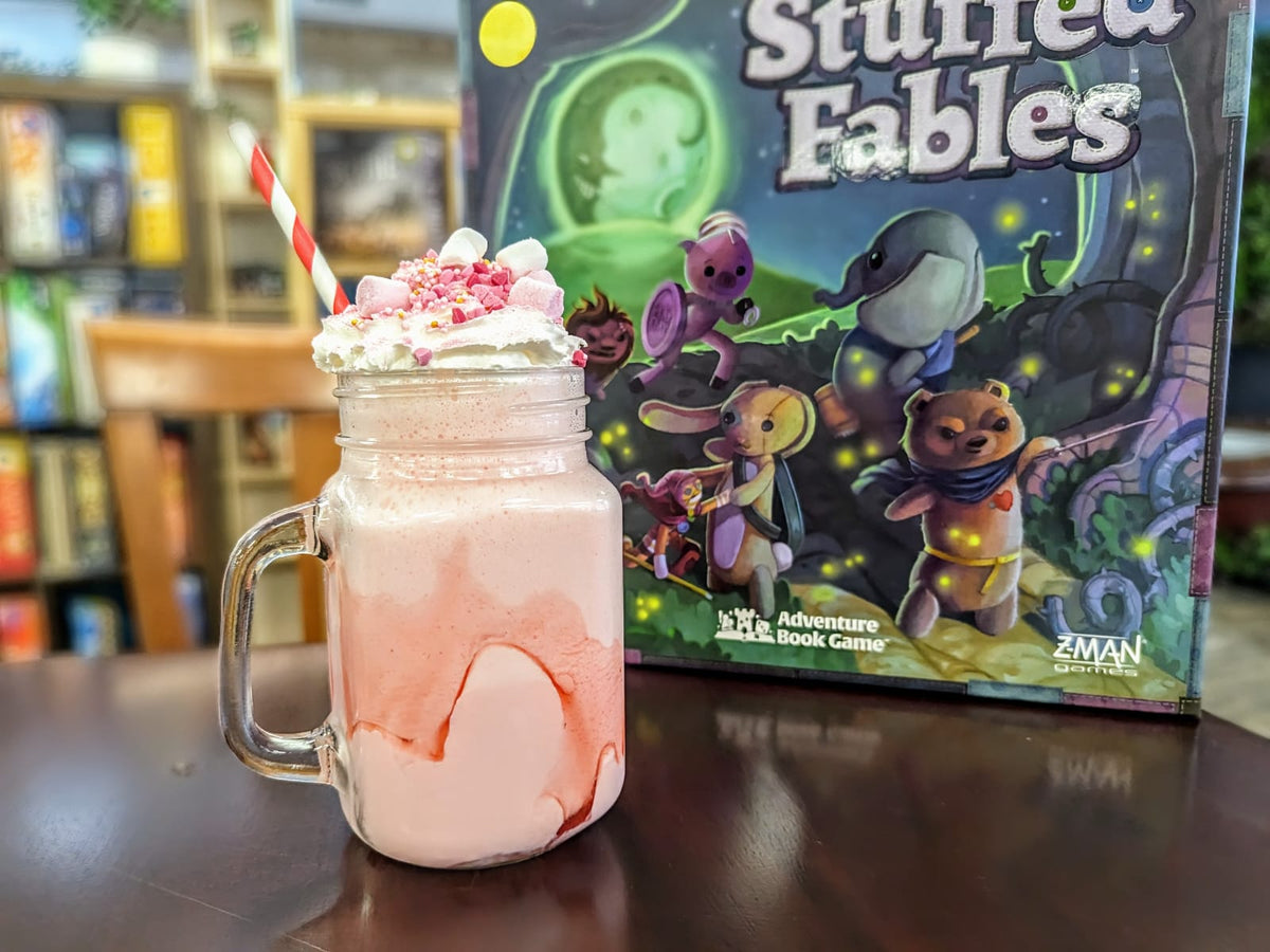 A milkshake with a board game in the background